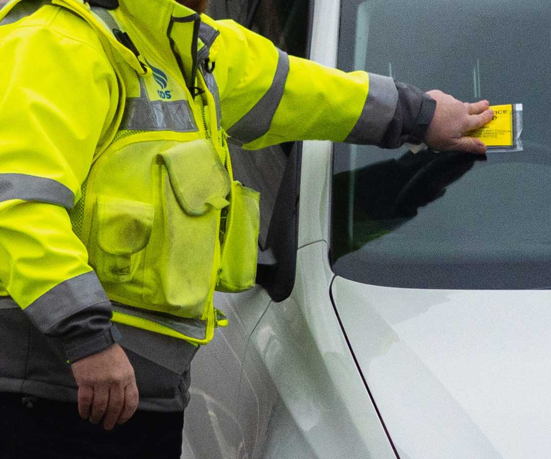 Parking ticket being put on vehicle